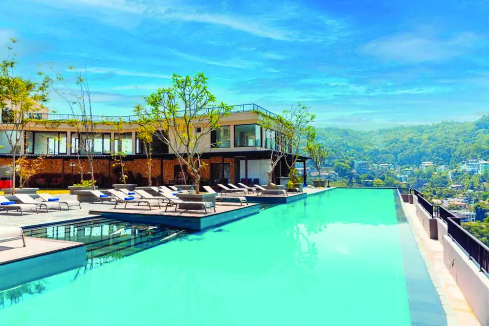 An infinity pool overlooking green hills